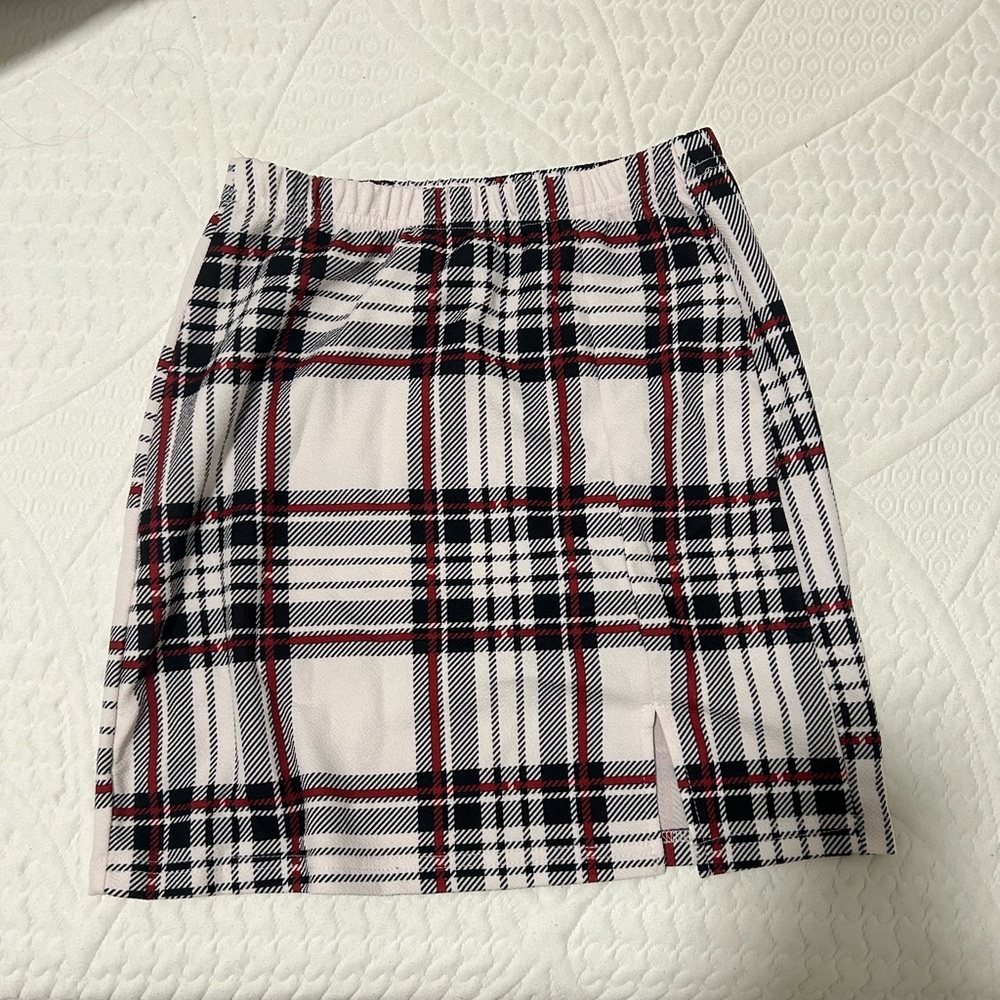 White skirt with black and red plaid stripes
